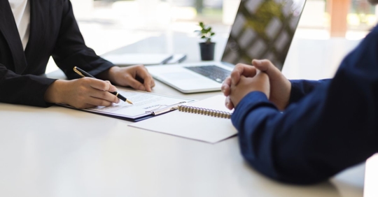 Employer talking to a prospective employee about the employee's proposed contract with the company.