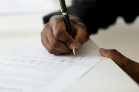 man signing legal documentation